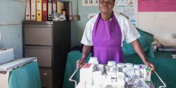A nurse stands in the Chikurubi prison clinic with a trolley of medicines in front of her