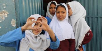 Young schoolgirls pose outside their classroom in Rawalpindi City