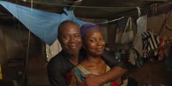 Duada Sama holds his wife Issatta as they smile inside their home