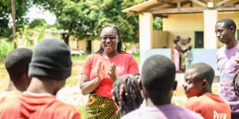 Volunteer Monica Atim talks to a group of peer educators she's trained