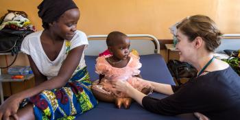 Volunteer paediatrician examines a two year old