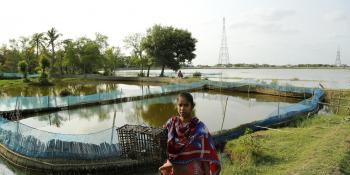 Woman standing outside next next to a river, crab fishing