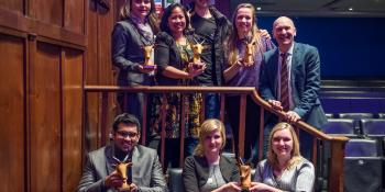 A group of people holding their awards