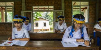 Girls study after going back to school in Myanmar.