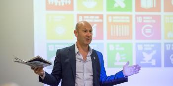 VSO Chief Executive Philip Goodwin speaks animatedly at a conference about the Sustainable Development Goals