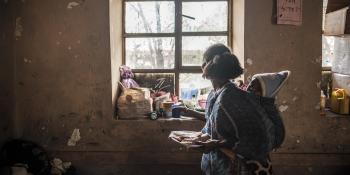 Mother with baby holds a plate of food