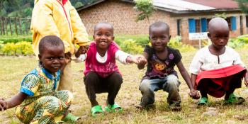 Young children play with the volunteers