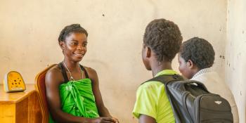 Regina Mwaba sharing her story and encouragement to some young girls inside the Youth Friendly Space at Mbabala Clinic.