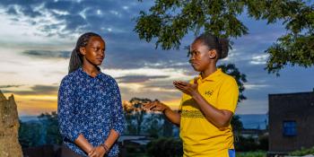 Brown, a VSO deaf volunteer discussing with Joy, a sign language interpreter