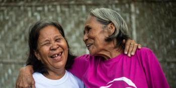 Pilipino community volunteer Jovencia laughs with her friend 