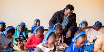 Theo sits in the learning centre with a student