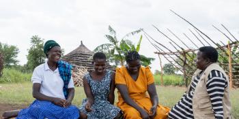 Four women together laughing.