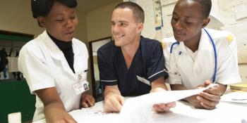 David Atherton with his students Diana Liphana and Stevien Saiwala. David, THET programme VSO volunteer at work in St Lukes Hospital, Zomba district, Malawi