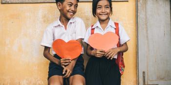 Children hold paper hearts in Cambodia