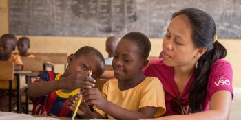 7-year-old Blessing Asokiyine (centre) with her 6-year-old classmate Klevin Atinga and VSO volunteer Mary Carnable, at Goriko kindergarten in Talensi District, Bolgatanga, Ghana