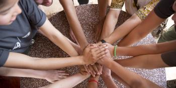 ICS volunteers join hands ICS volunteers join hands in a circle