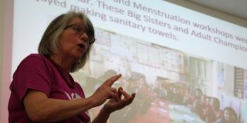Former volunteer gives a talk at a community event.