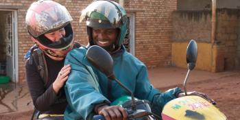 CUSO-VSO volunteer Anna MacEachern is setting off for work on a motorbike. Anna is working as a Basic Methodology Trainer in Ngoma district, Rwanda. CUSO-VSO volunteer Anna MacEachern is setting off for work on a motorbike. Anna is working as a Basic Methodology Trainer in Ngoma district, Rwanda.