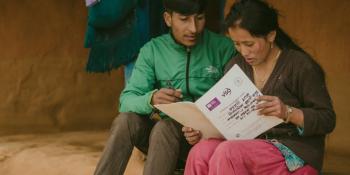 People read a VSO document as part of the One Community, One Family research project in Nepal
