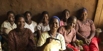 Women hold up solar lanterns in Malawi