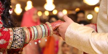 Pakistani couple at wedding, close-up of them holding hands Pakistani couple at wedding, close-up of them holding hands