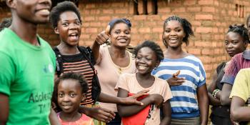 group of people in zambia smiling and laughing at the camera