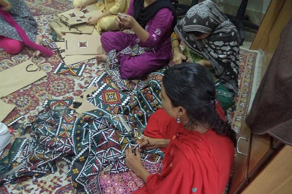 Women participating in a sewing workshop at Panah shelter