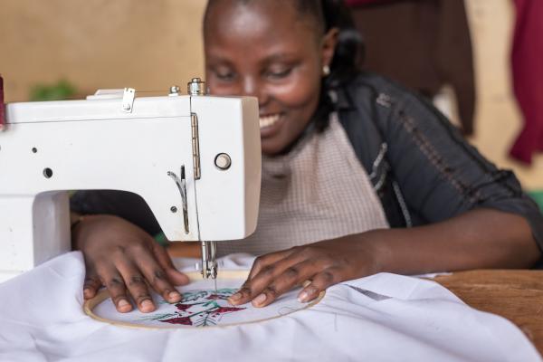 Tailor Christine Syombua using her sewing machine