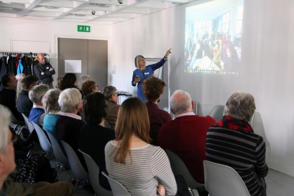 A returned volunteer gives a presentation about her VSO professional volunteering placement