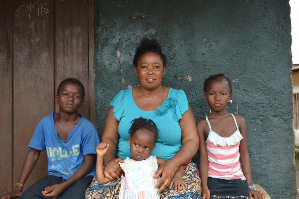 Kadiatu Joe sits with her three young children