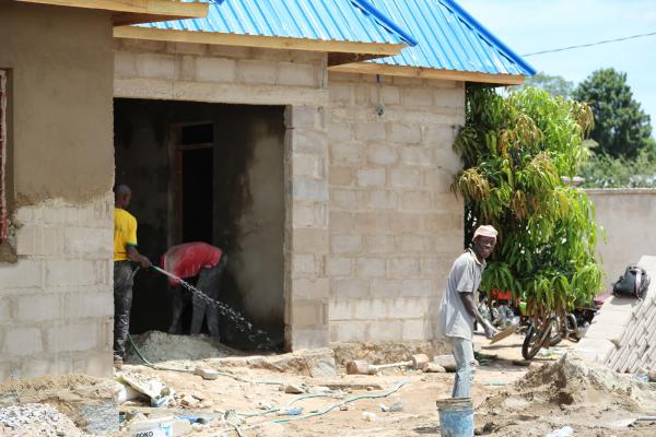 Men working to build a breezeblock building