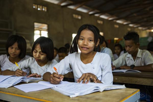 Schoolgirls working at their desk in the classroom at at Kyakathone primary school, Mon state.