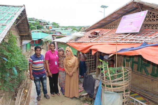 Ann Wambui, in pink, is here with two community volunteers and a Rohingya mother.