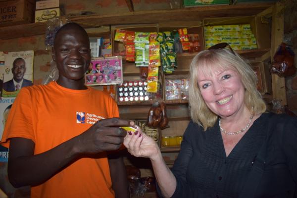 Sue with shopkeeper who has been able to expand his stock.