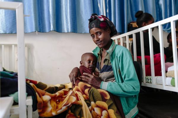 A mother holds her one-year old son in the new high-dependency unit at Nigist Eleni Mohammed Memorial Hospital
