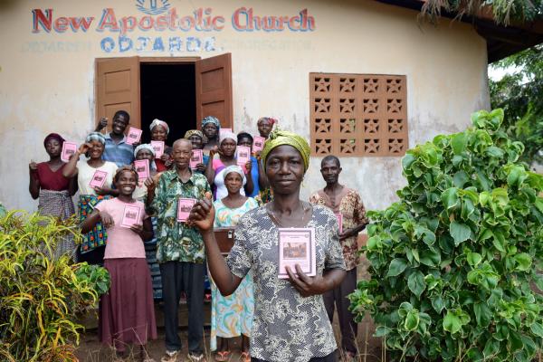 Members of the Odjarde Village Savings and Loan Association proudly hold their savings books