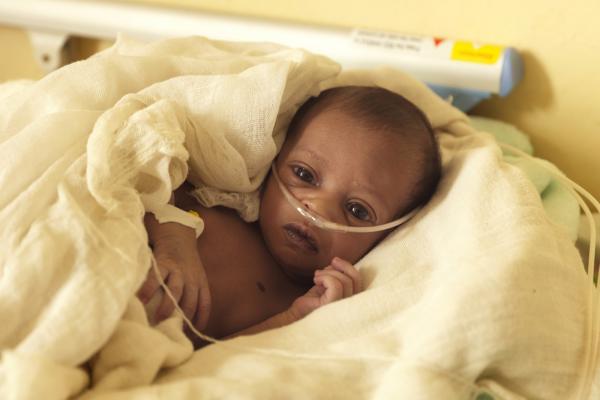 A newborn baby receives oxygen