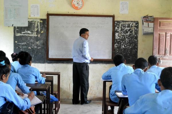 A teacher and students in a classroom in Nepal on World Teachers Day