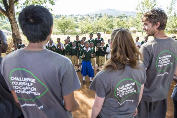 ICS volunteers watch and listen to a song performed by the pupils of Endagikot school
