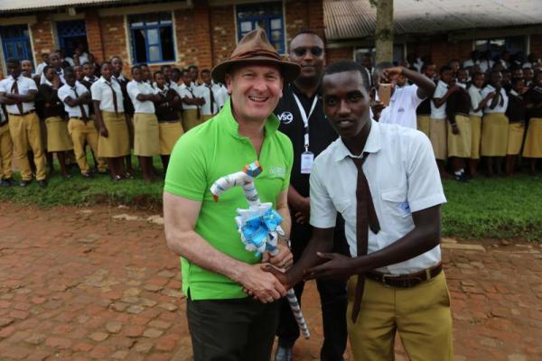 VSO CEO accepts a gift outside a school in rwanda