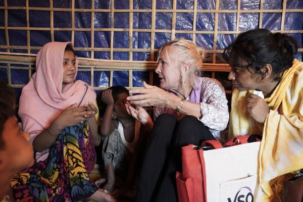 International volunteer Fiona Kirby talks with mothers at a home-based learning centre in the Cox's Bazar camp