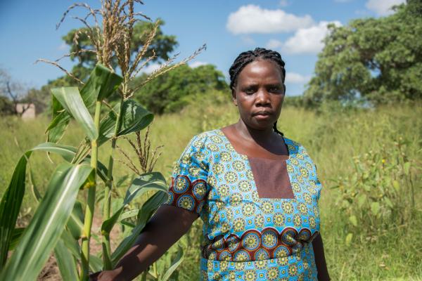 Suzana Capitao stands outside by her crops