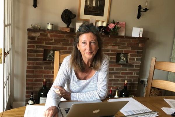 Communications volunteer Diana Holmes sits at her desk while working from home.