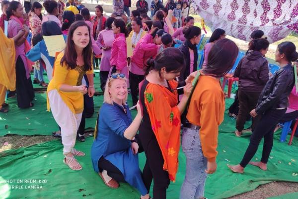 Volunteer Nicola standing with Big Sisters at outdoor team building event in Surkhet, Nepal.