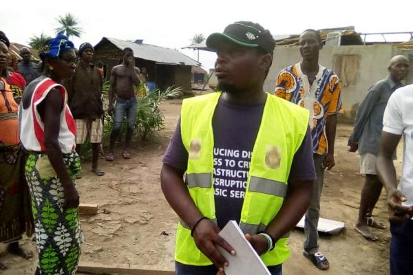 VSO-trained volunteer James Lansana distributing information about COVID-19