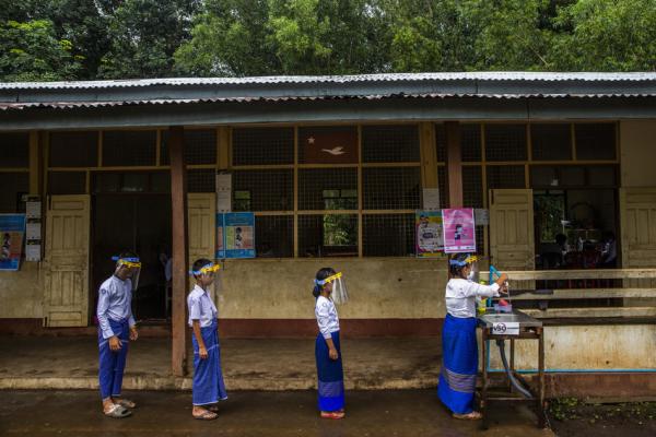 Children line up to have their hands washed at school in Mon state, Myanmar.