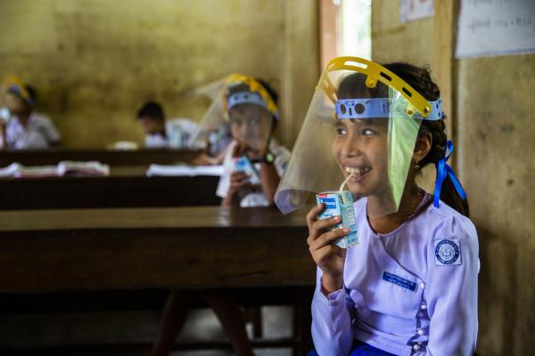 Schoolgirl Mi A Mee Thaw drinks milk in a classroom in Mon state, Myanmar.
