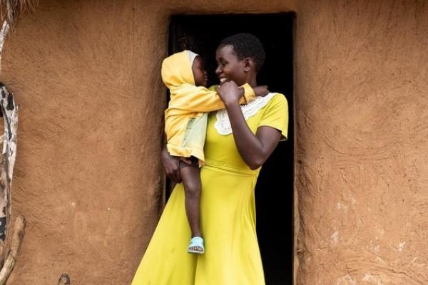 Consolata at home with her child