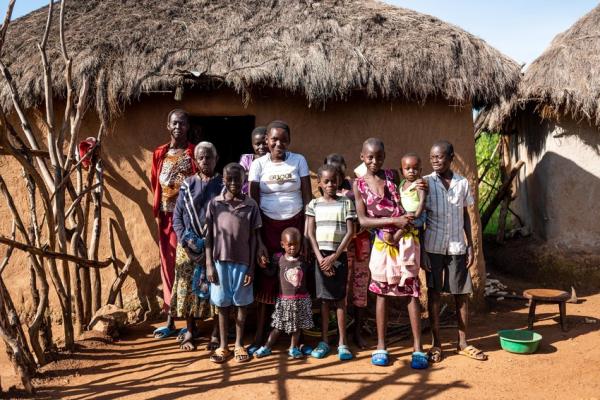 Consolata (18 years old) at home with her family, including her mother Penina Mbusuro Chacha (38 years old) and her grandmother Pauline Wantora (age unknown).