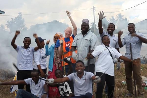 Khamis Mohamed happy with a group of VSO volunteers